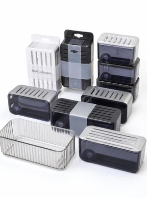 several plastic containers with lids are lined up on a white surface