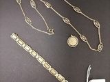 a close up of a necklace and a bracelet on a table