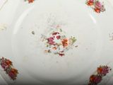 a white plate with flowers on it on a table