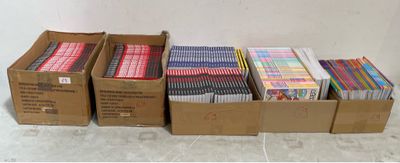 several boxes filled with different colored pencils sitting on top of a counter