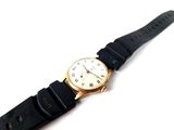 an image of a close up of a wrist watch on a white surface