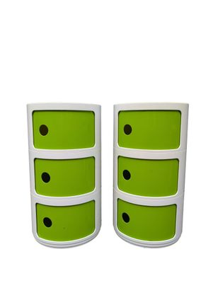 two white and green drawers with black dots on them