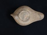 a stone object that looks like a bird on a black background