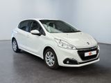 the small white car is parked in a large room
