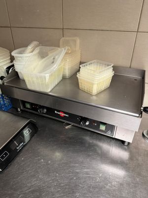 several containers of food sit on top of a counter in a kitchen