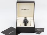 a close up of a watch in a box on a white surface
