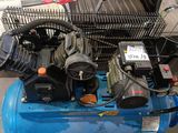 a blue air compressor sitting on top of a blue cart