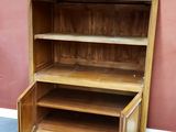 a wooden cabinet that has a drawer in it