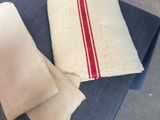 a stack of towels on a blue chair with a red stripe on it
