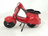 a toy scooter that is sitting on a white surface