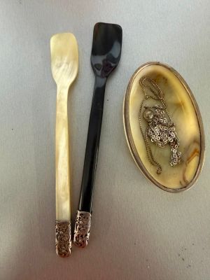 two spoons, a spoon and a spoon rest on a table