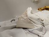 a pile of clothes sitting on top of a washing machine