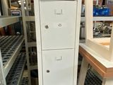 a tall white filing cabinet in the middle of a room