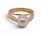 a close up of a pearl ring on a white background