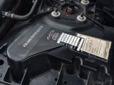 a close up of a car engine with a sticker on it
