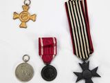 three medals and a medal are on a white surface