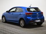 the rear end of a blue car parked in a room