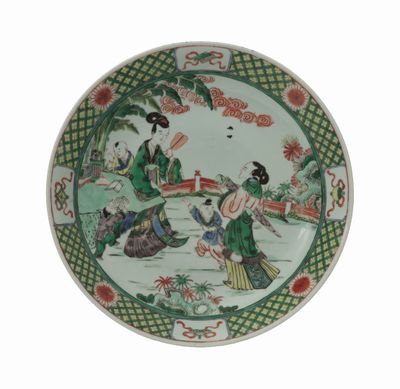 une assiette sur laquelle est représentée une femme et un chien