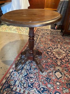 une photo d'une table en bois posée sur un tapis dans un salon