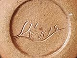 a close up of a brown plate with a name on it