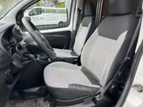 the interior of a small van with two seats and a steering wheel