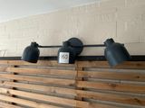 three lights on the wall above the bed