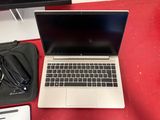 a laptop computer sitting on top of a red table