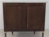 a small wooden cabinet with a marble top on a tile floor