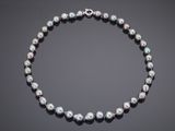 a black pearl necklace with a silver clasp