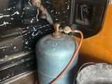 a propanent and a bucket of water in the back of a truck