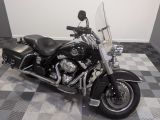 a black motorcycle that is parked on a checkered floor