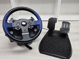 a steering wheel and pedals sitting on a table