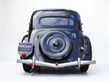 a blue car that is sitting on a white surface