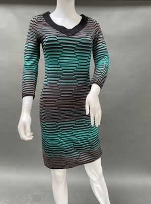 a mannequin wearing a green and black striped dress