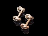 two pieces of rope on a black surface with a black background