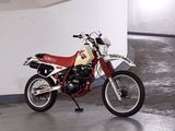 a red and white motorcycle parked in a parking garage