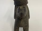an old wooden statue of a dog with a hat on it ' s head