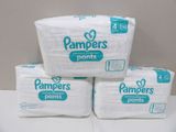 three packs of pampers pants sitting on top of each other