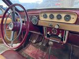 a dashboard and steering wheel of an old car