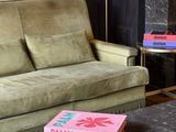 two books on a table in front of a couch