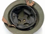 an old military helmet with a hole in the middle of it