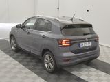 the back end of a grey volkswagen suv parked in a garage