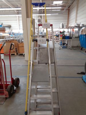 a picture of a large warehouse with a ladder and a hand truck