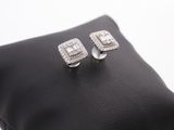 pair of white gold and diamond earrings on a black leather case