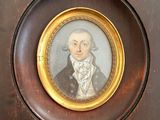 portrait of a man in a suit and tie in a wooden frame
