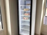 a refrigerator that is sitting in the corner of a room