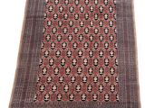 an antique persian rug with geometric design and fringe fringes