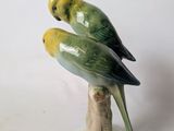 two birds that are sitting on top of each other