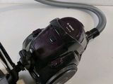 a black and purple vacuum sitting on a white counter