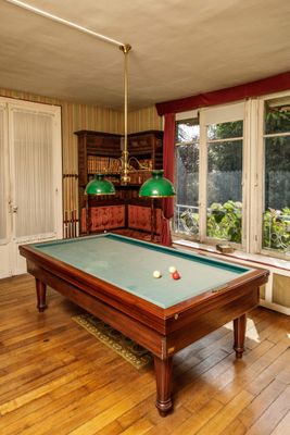 a pool table in the middle of a living room